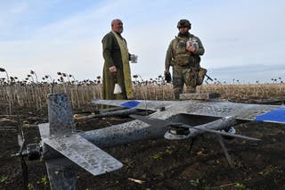 An orthodox chaplain sprinkles holy water on a combat drone near Zaporizhzhia last week